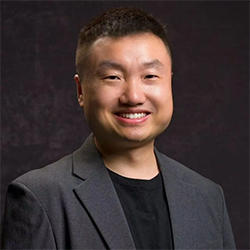 A person in a suit  Description automatically generated