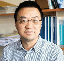 A person wearing glasses and a striped shirt  Description automatically generated