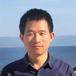 A person smiling at the camera  Description automatically generated