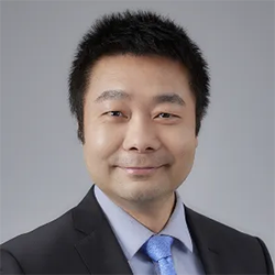 A person in a suit and tie  Description automatically generated